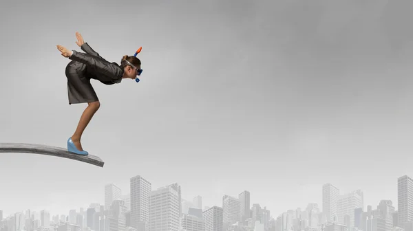 Businesswoman jumping in water