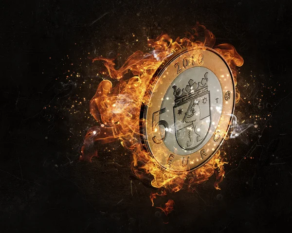 Euro coin burning in fire — Stock Photo, Image