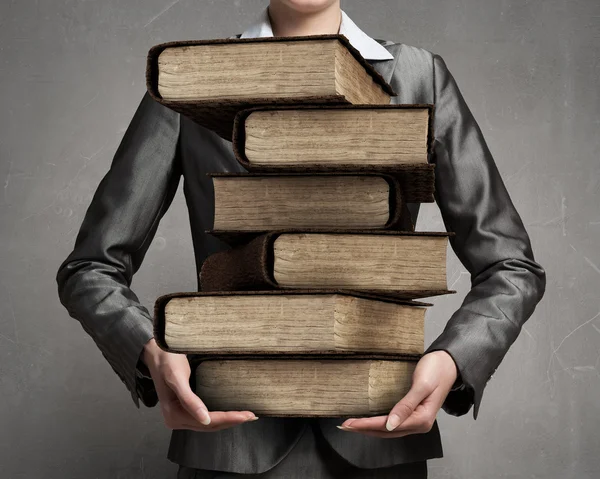 Woman carrying stack of books — Stock Photo, Image