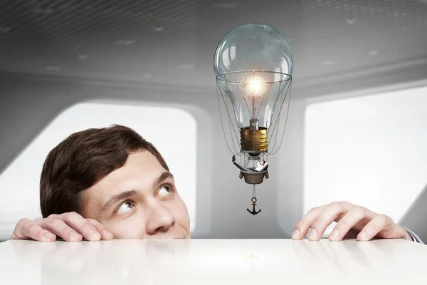 Businessman peep from under table — Stock Photo, Image