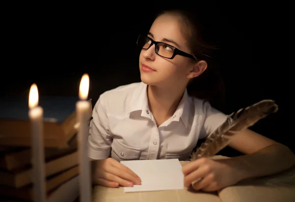 Young girl writing with feather — Stock Photo, Image