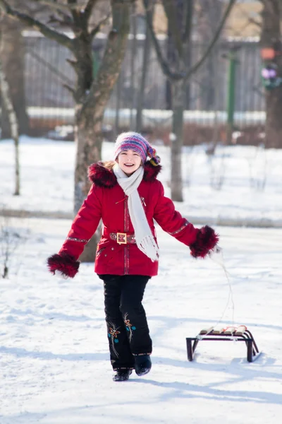 Girls with sledge rest at winter snow — Stock Photo, Image