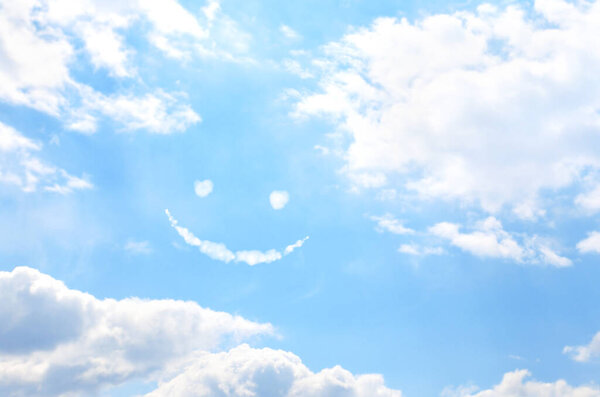 Happy concept. Smilie from white cloud in the blue sky 