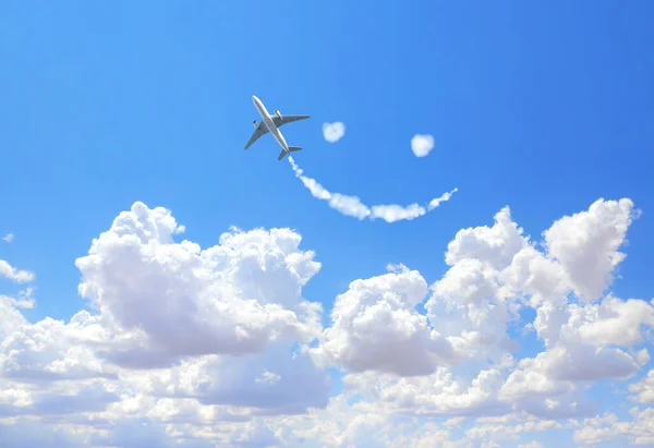 Aircraft draw a smile in the sky. Flight route of aircraft in shape of a face. Happy concept for traveling the world. Smilie from white cloud in the blue sky