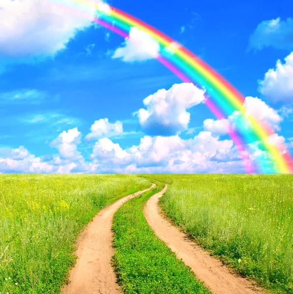 Rural landscape with old road and rainbow — Stock Photo, Image