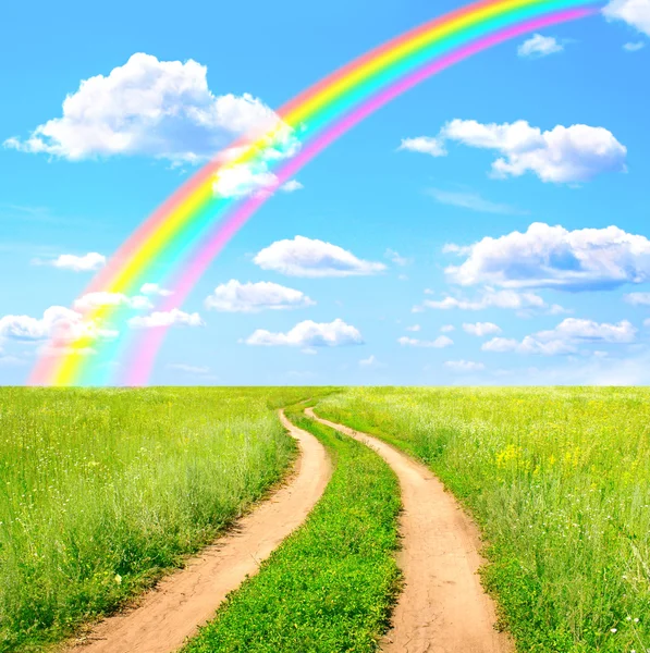 Rural landscape with old road and rainbow — Stock Photo, Image