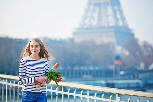 Girl with traditional French baguette and tulips — Stock Photo, Image