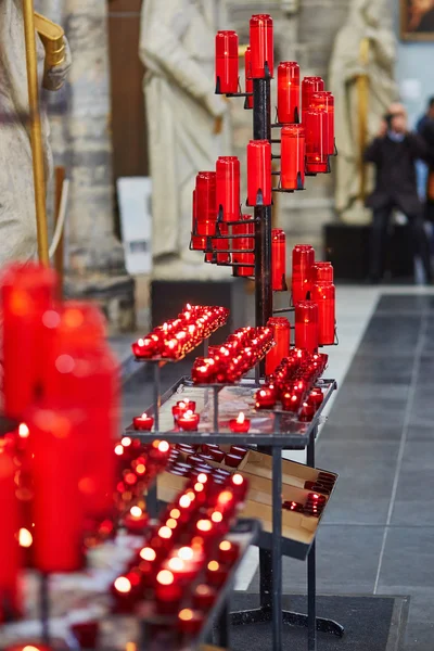 Church candles in red chandeliers — Zdjęcie stockowe