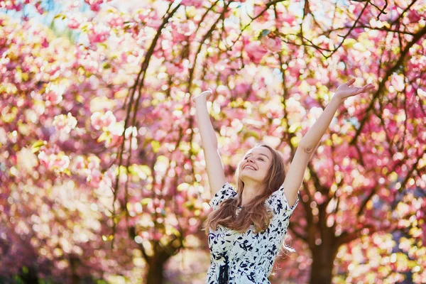Ragazza in giardino di fiori di ciliegio in un giorno di primavera — Foto Stock