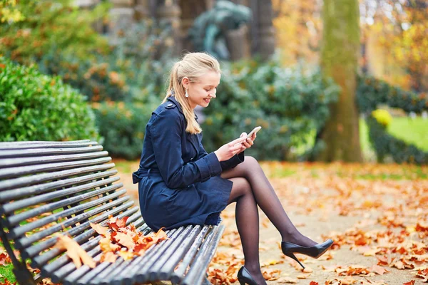 Beautiful young woman on a street of Paris on a sunny fall day — Stock Photo, Image