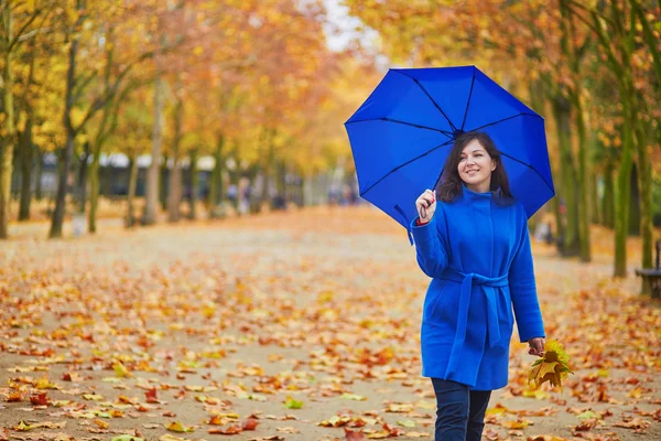 Beautiful young woman with blue umbrella — Stock Photo, Image