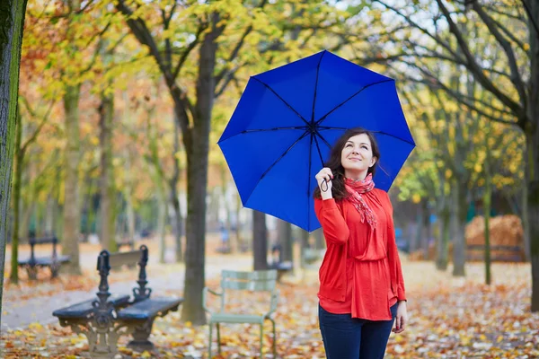 Beautiful young woman with blue umbrella — Stock Photo, Image