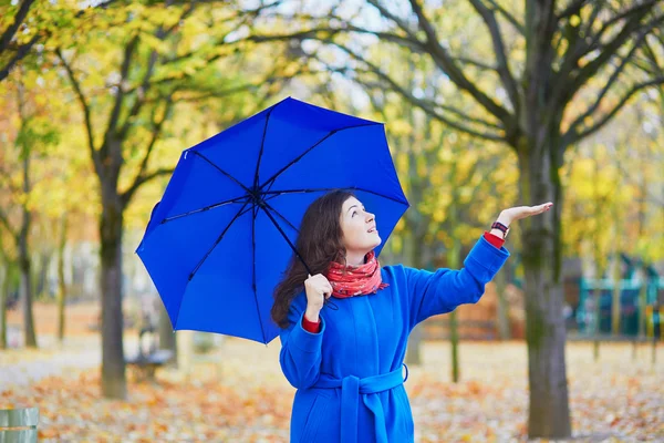 Beautiful young woman with blue umbrella — Stock Photo, Image