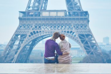 Romantic couple near the Eiffel tower in Paris, France clipart