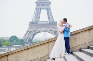 Just married couple near the Eiffel tower in Paris clipart