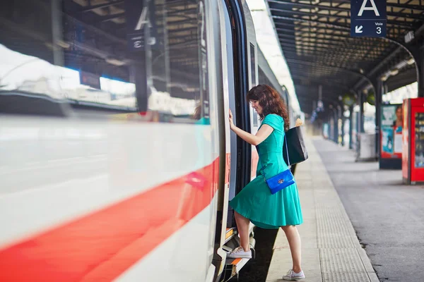 Giovane donna sul binario di una stazione ferroviaria — Foto Stock