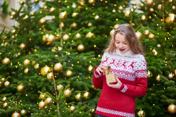 Junge Frau auf einer weihnachtlich geschmückten Straße in Paris — Stockfoto