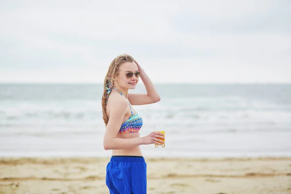 Woman relaxing and sunbathing on beach, drinking delicious fruit juice — 图库照片