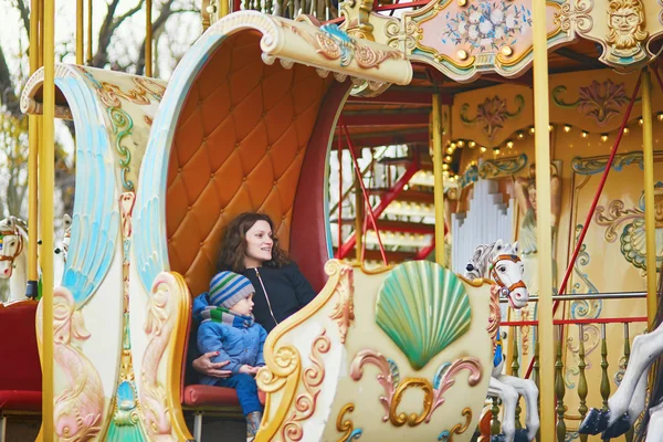 Mother with her little son on merry-go-round in Paris — Stock Photo, Image