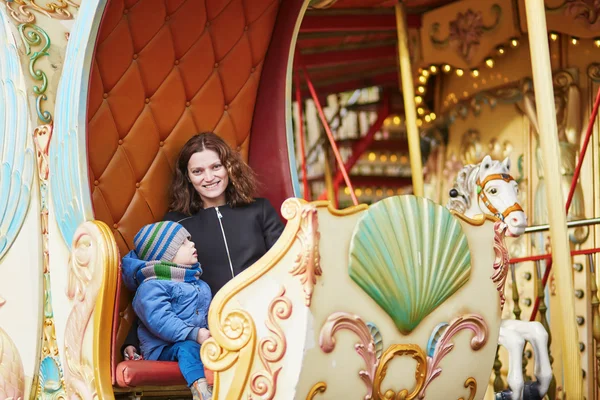 Mother with her little son on merry-go-round in Paris — Stock Photo, Image