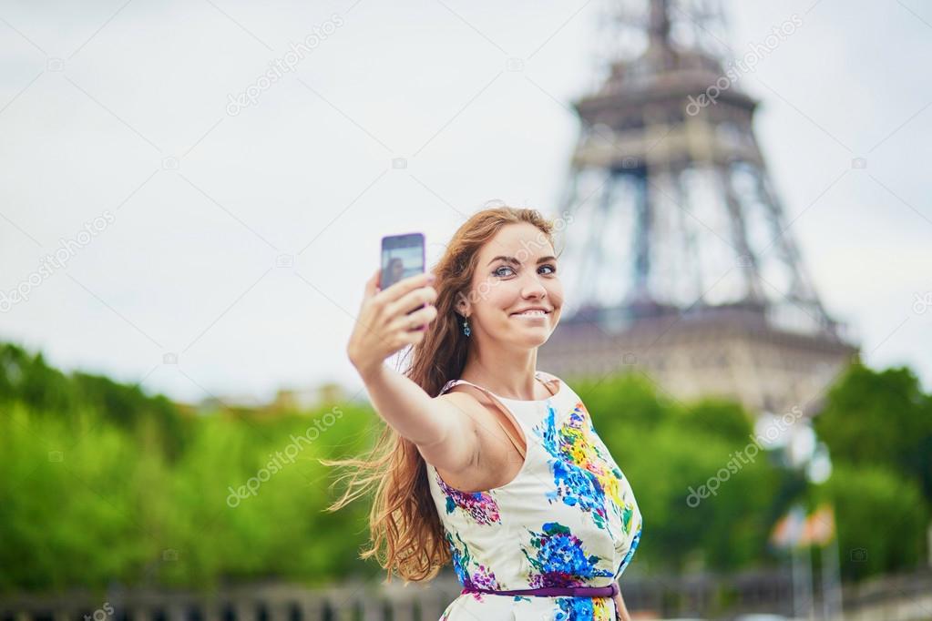 Beautiful French woman walking near the Eiffel tower