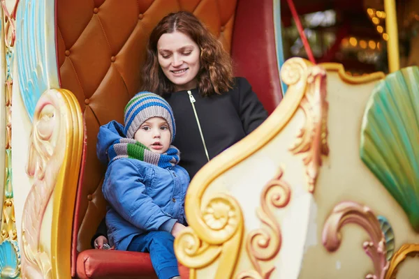 Mother with her little son on merry-go-round in Paris — Stock Photo, Image