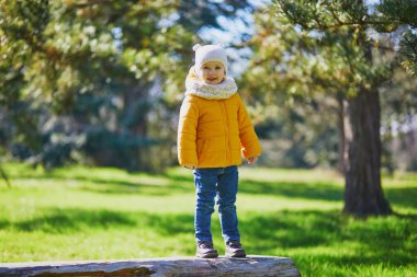 Mutlu çocuk bir bahar günü parktaki ya da ormandaki ahşap kütükte