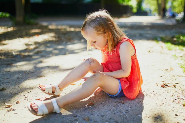 Χαριτωμένο Κοριτσάκι Που Κάθεται Στο Έδαφος Αφού Έπεσε Κάτω Παιδί — Φωτογραφία Αρχείου
