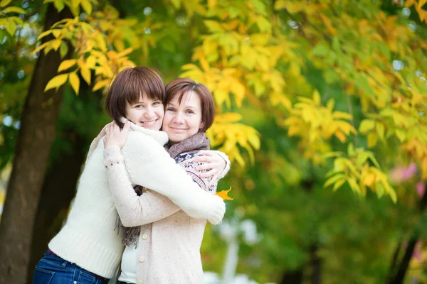 Middle aged woman with daughter on a fall day — Stock Photo, Image