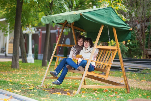 Mother with daughter on a swing — Stock Photo, Image