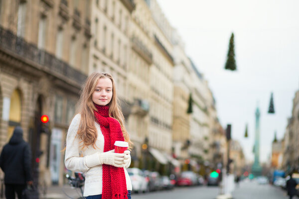 Girl with take away coffee on a Parisian street