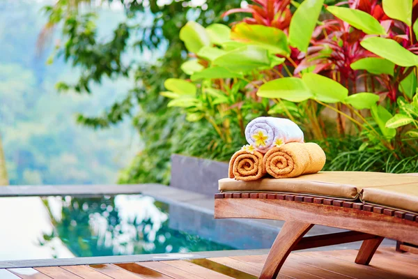 Toallas con flores de frangipani en el spa balinés —  Fotos de Stock