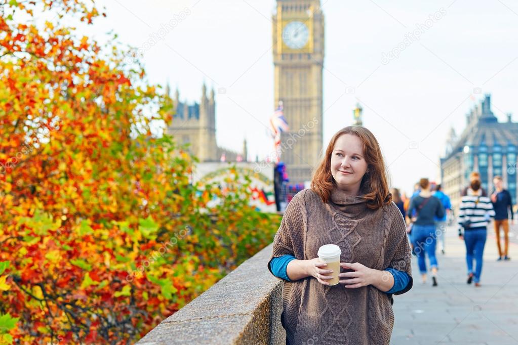 Tourist in London walking with coffee 