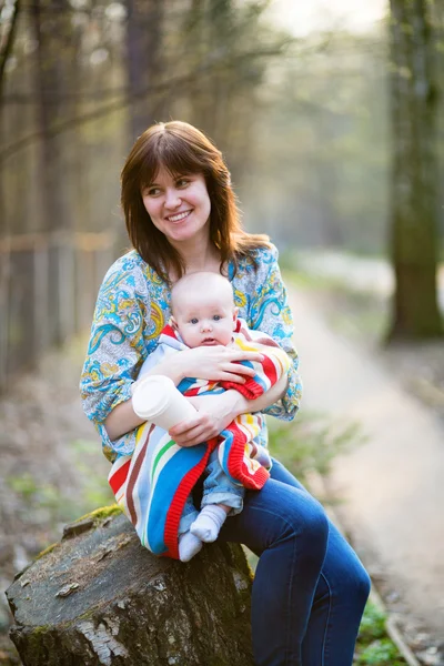 Young mother with her baby boy in forest — Stock Photo, Image