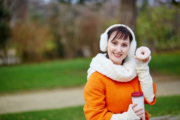 Cheerful young woman with donut — Stock Photo, Image