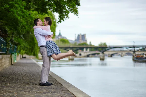 Couple is walking by the water in Paris — Stock Photo, Image