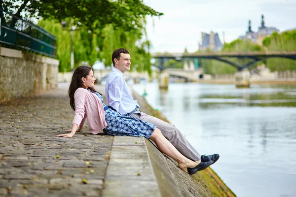 Couple is sitting on the embankment — Stock Photo, Image