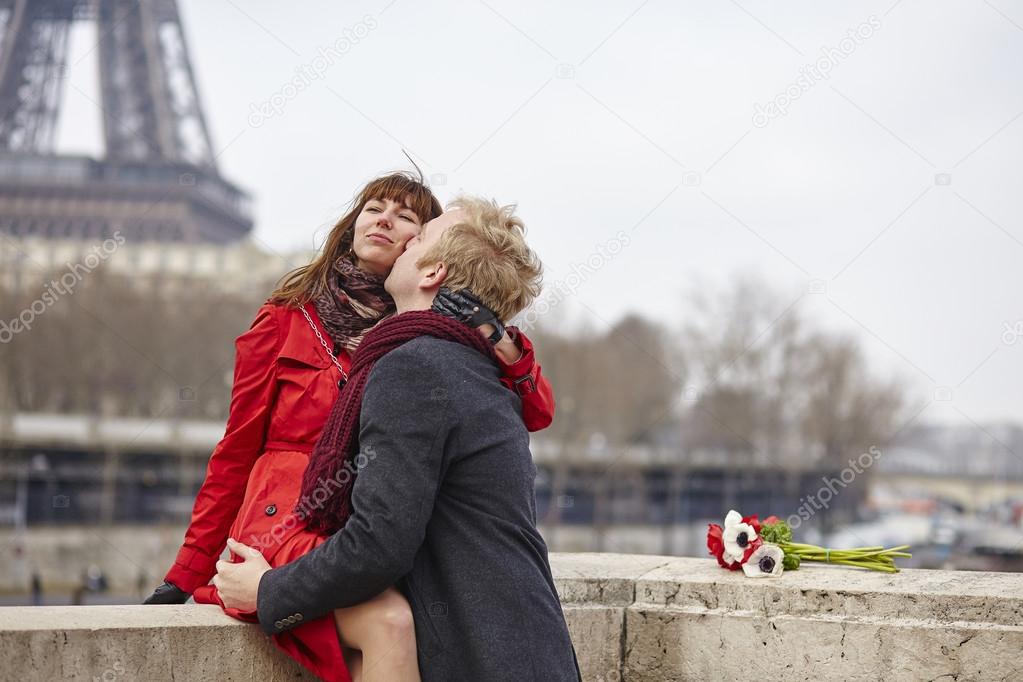 Couple in love in Paris, near the Eiffel tower