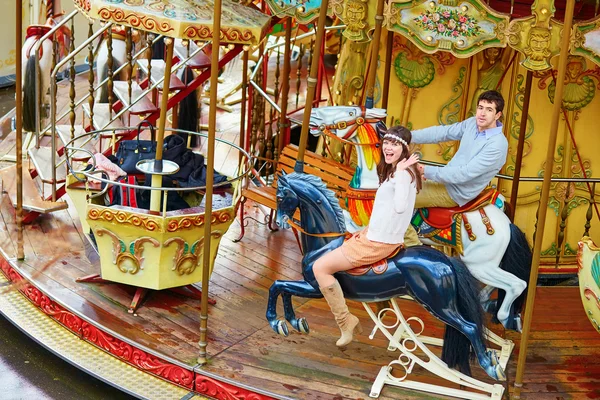 Happy couple on the merry-go-round in Paris — Stock Photo, Image