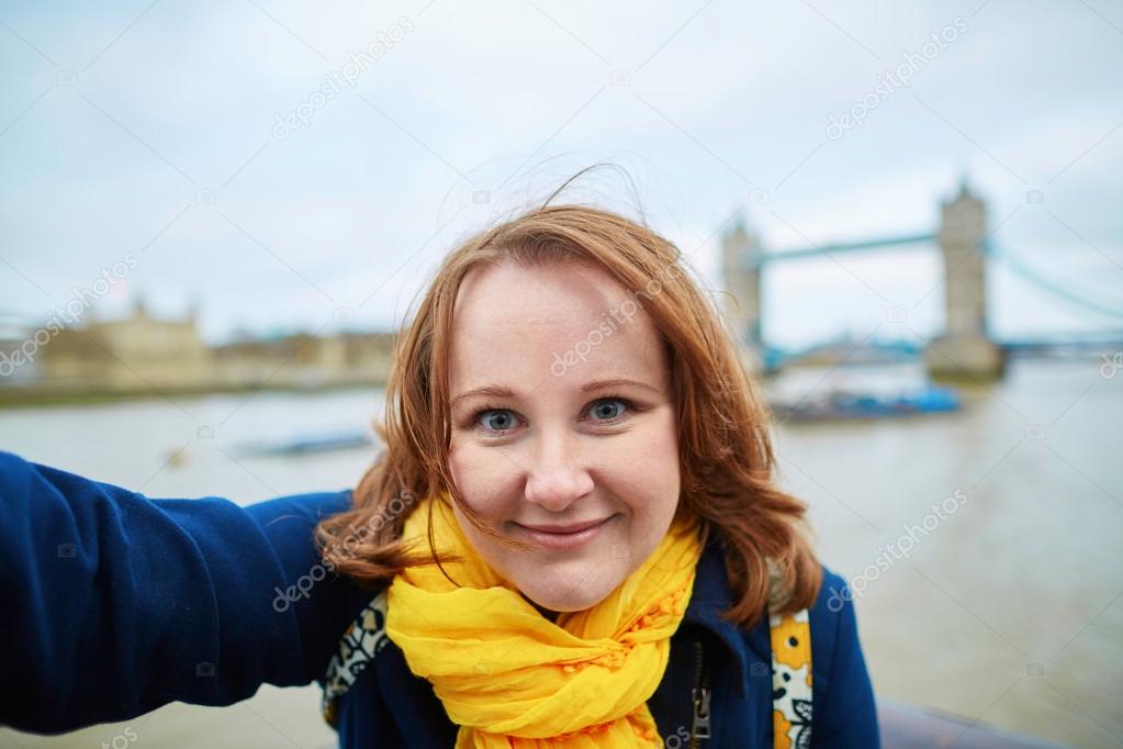 Tourist taking a self picture with Tower bridge