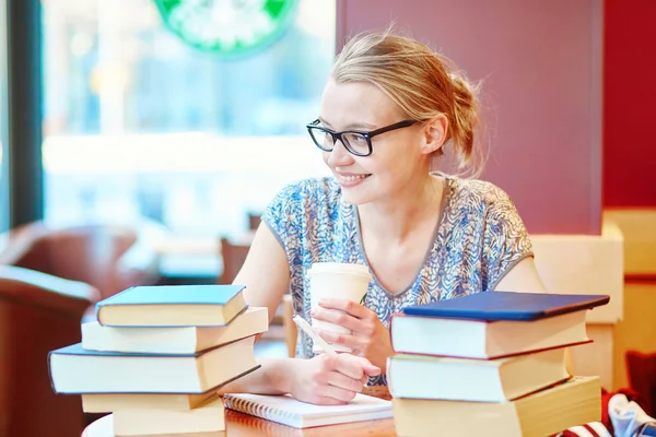 Beautiful young student with lots of books — Stock Photo, Image