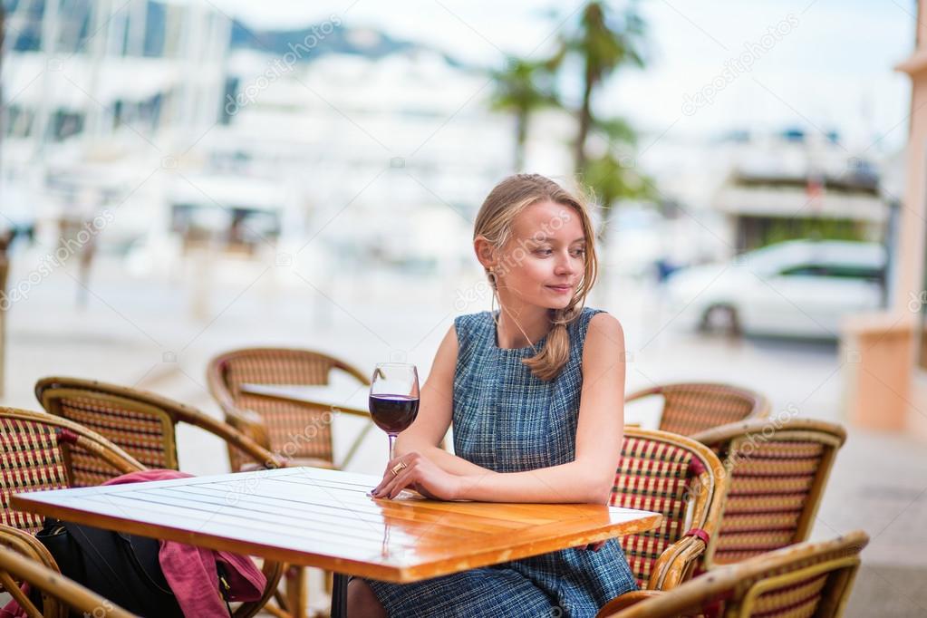 French woman in an outdoor cafe of Cannes