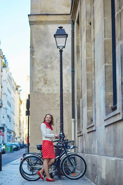 Beautiful young woman with a bicycle — Stock Photo, Image