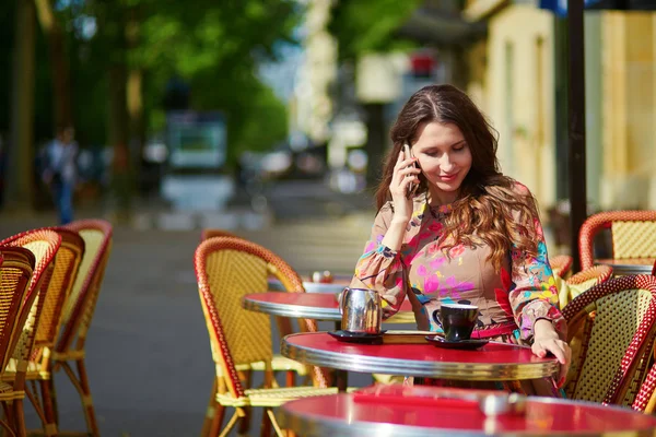 Beautiful young woman in Parisian cafe — Stock Photo, Image