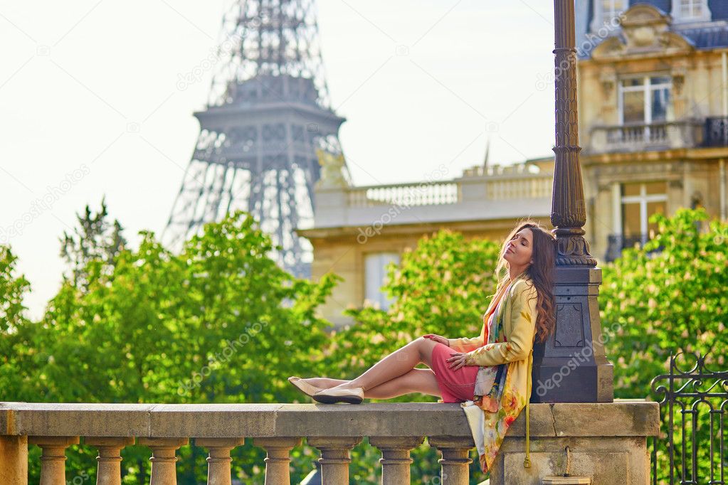 Beautiful young woman near the Eiffel tower