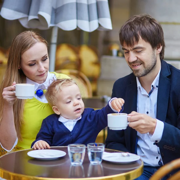 Happy family of three in Parisian cafe — Stock Photo, Image