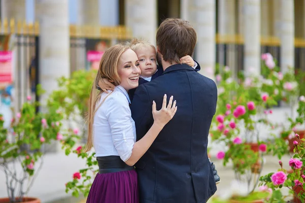 Happy family of three in Paris on a summer day