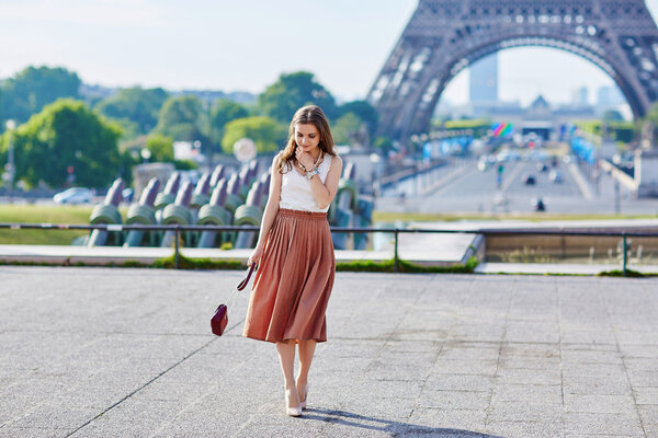 Beautiful young Parisian woman near the Eiffel tower