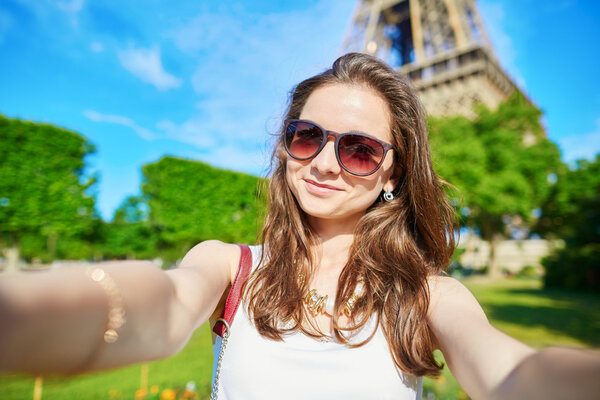 Beautiful young tourist in Paris taking selfie