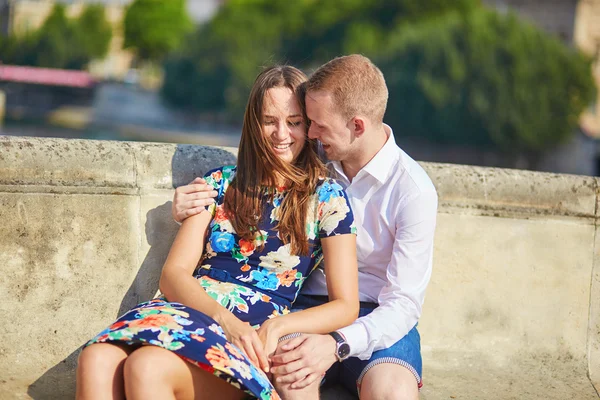 Jeune couple romantique ayant sur le quai de la Seine — Photo